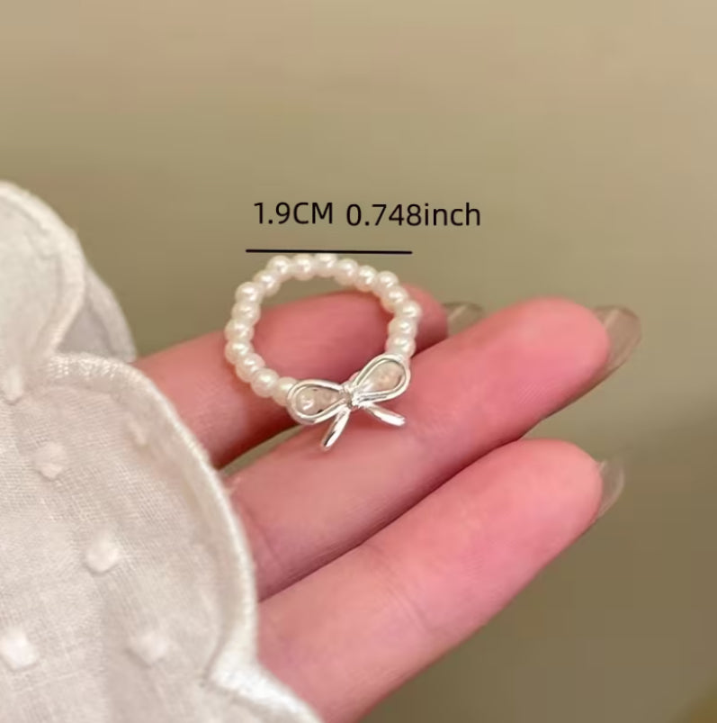 A Set of Three Bow Shaped Imitation Pearl Rings